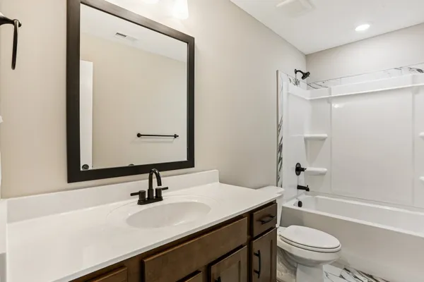 a bathroom with a sink a toilet and a mirror