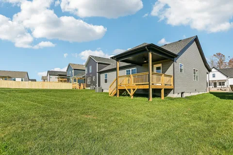 a view of a house with a backyard