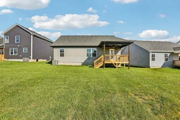 a view of a house with a backyard