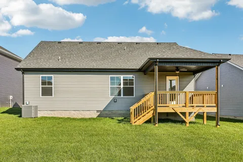 a view of a house with a big yard and large trees