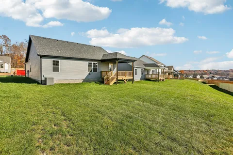 a view of a house with a yard and sitting area