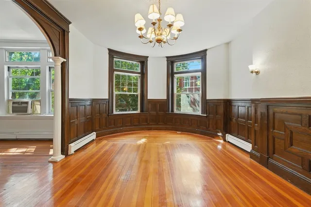 a view of a room with wooden floor and staircase