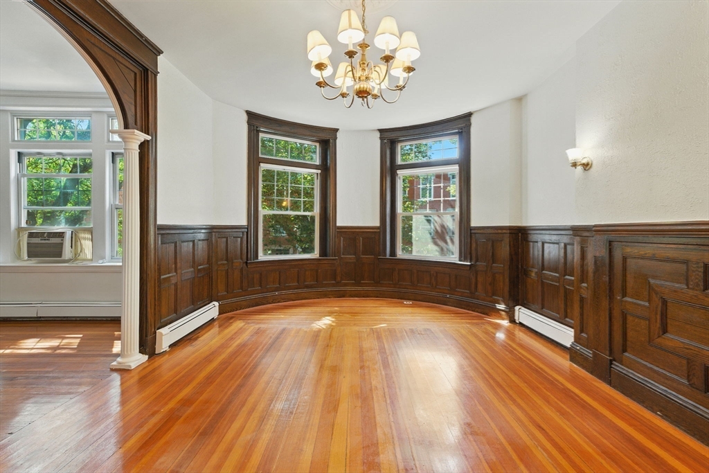 17 Strathmore Road, Unit 2 Brookline, MA 02445 - Photo 12 of 32 a view of an empty room with wooden floor and a window