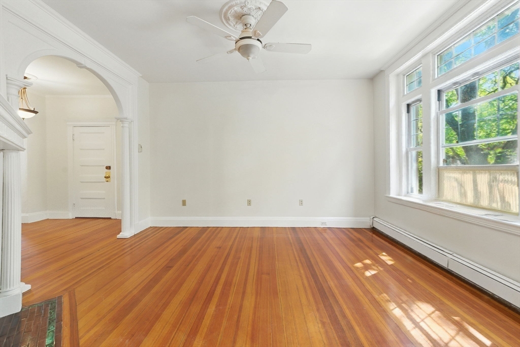 17 Strathmore Road, Unit 2 Brookline, MA 02445 - Photo 15 of 32 wooden floor in an empty room with a window