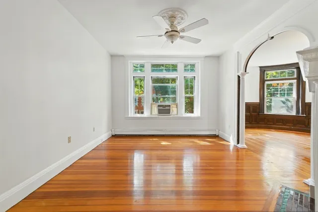 a view of a dining room with furniture a chandelier and wooden floor