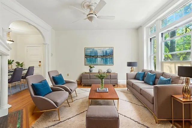 a view of a livingroom with wooden floor and a fireplace