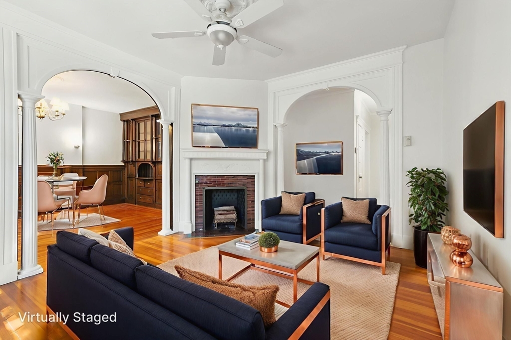 17 Strathmore Road, Unit 2 Brookline, MA 02445 - Photo 20 of 32 a living room with furniture a flat screen tv and a fireplace
