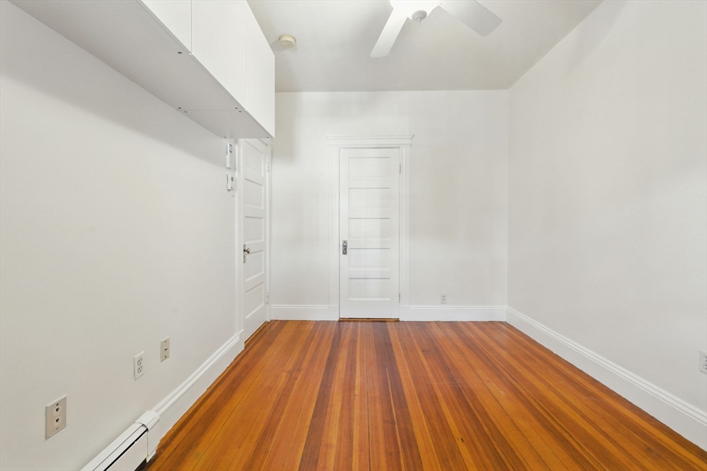 17 Strathmore Road, Unit 2 Brookline, MA 02445 - Photo 22 of 32 a view of a room with wooden floor and brick walls