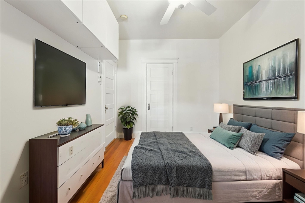 17 Strathmore Road, Unit 2 Brookline, MA 02445 - Photo 23 of 32 a bedroom with a bed and a flat screen tv