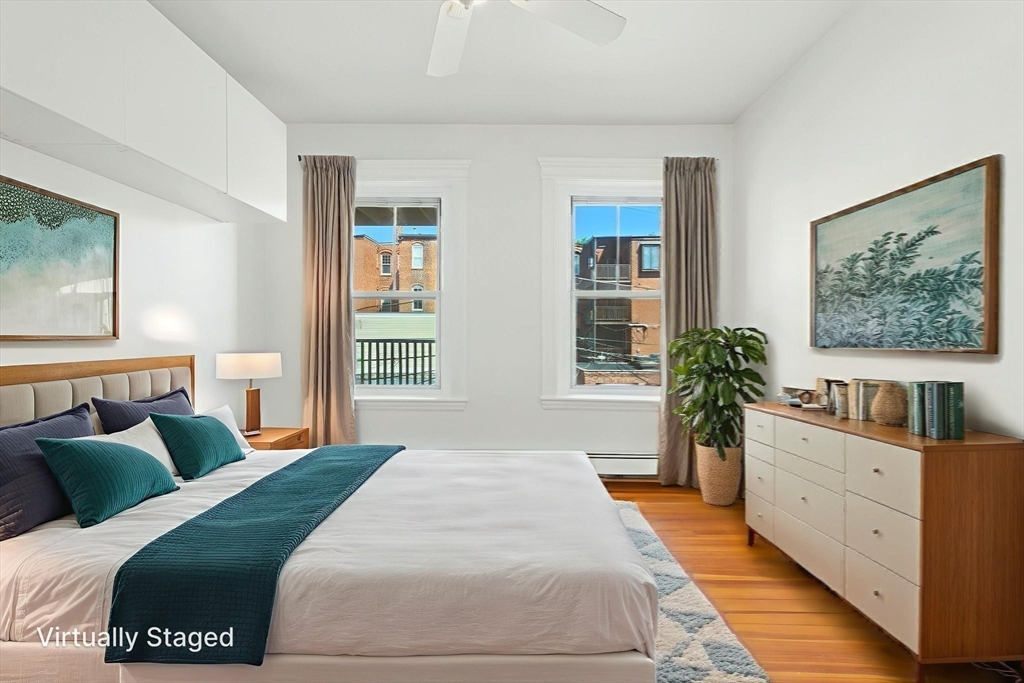 17 Strathmore Road, Unit 2 Brookline, MA 02445 - Photo 28 of 32 a bedroom with a large bed and a potted plant