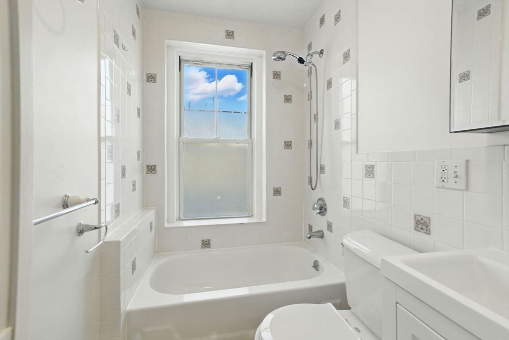 17 Strathmore Road, Unit 2 Brookline, MA 02445 - Photo 30 of 32 a white bath tub sitting next to a white sink and vanity