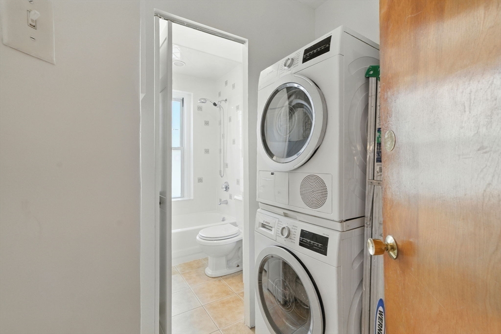 17 Strathmore Road, Unit 2 Brookline, MA 02445 - Photo 31 of 32 a view of a hallway with washer and dryer
