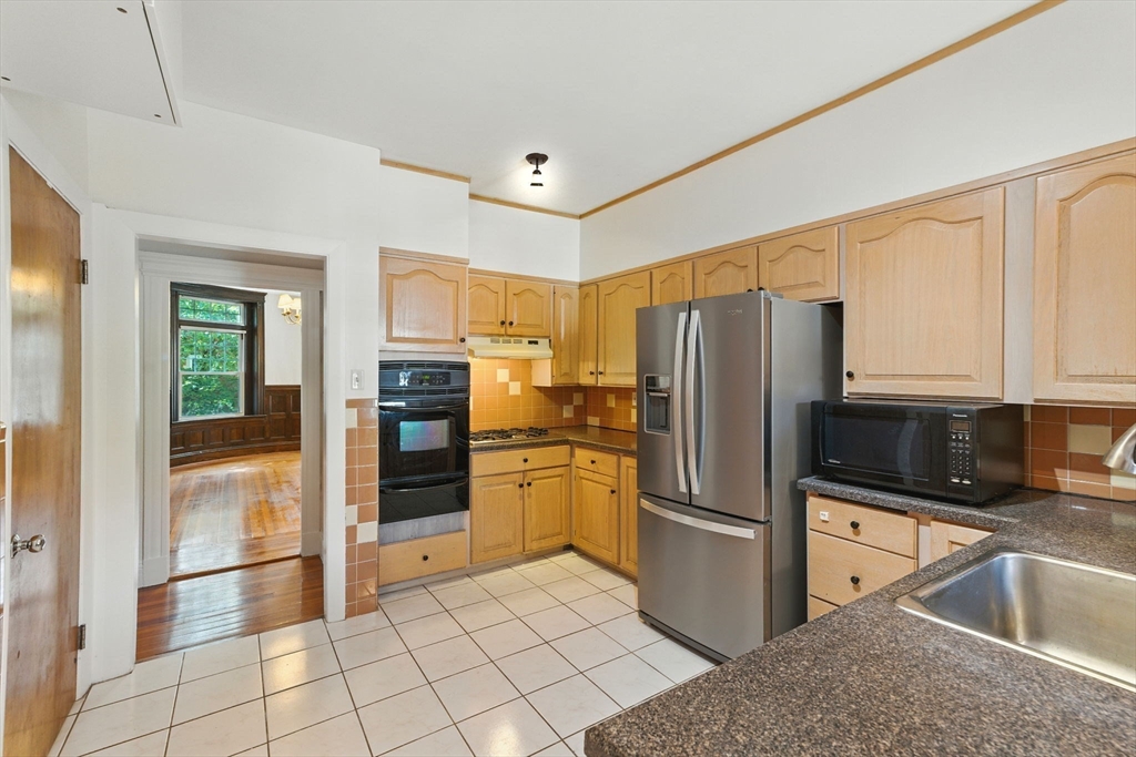 17 Strathmore Road, Unit 2 Brookline, MA 02445 - Photo 6 of 32 a kitchen with stainless steel appliances granite countertop a refrigerator and a sink