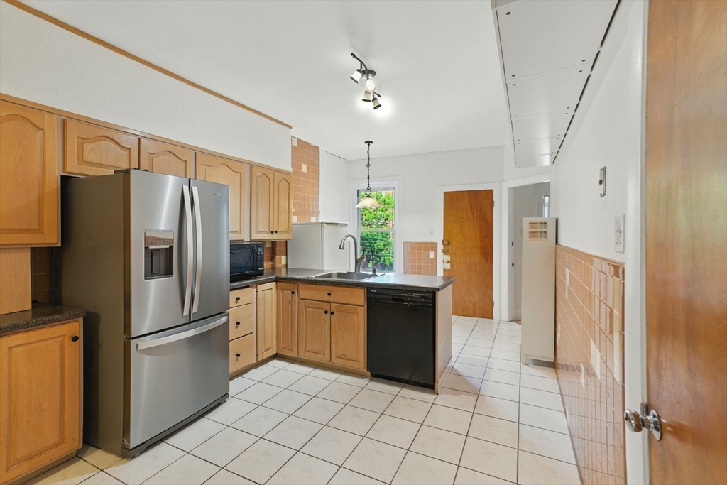 17 Strathmore Road, Unit 2 Brookline, MA 02445 - Photo 7 of 32 a kitchen with granite countertop a refrigerator and a sink