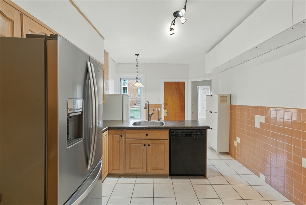 17 Strathmore Road, Unit 2 Brookline, MA 02445 - Photo 9 of 32 a kitchen with stainless steel appliances granite countertop a refrigerator and a stove