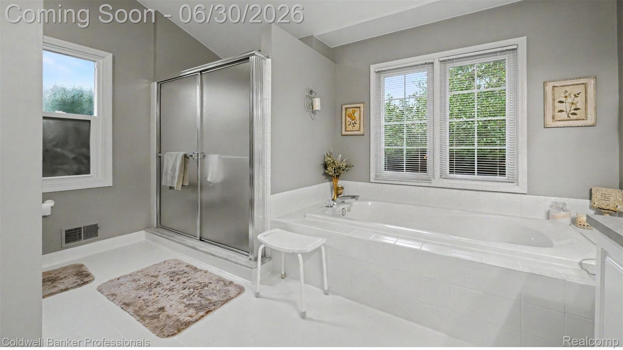 1085 Bloomview Circle Rochester, MI 48307 - Photo 35 of 67 Bathroom featuring a built-in soaking tub, separate shower with frosted glass doors, and two windows with white trim