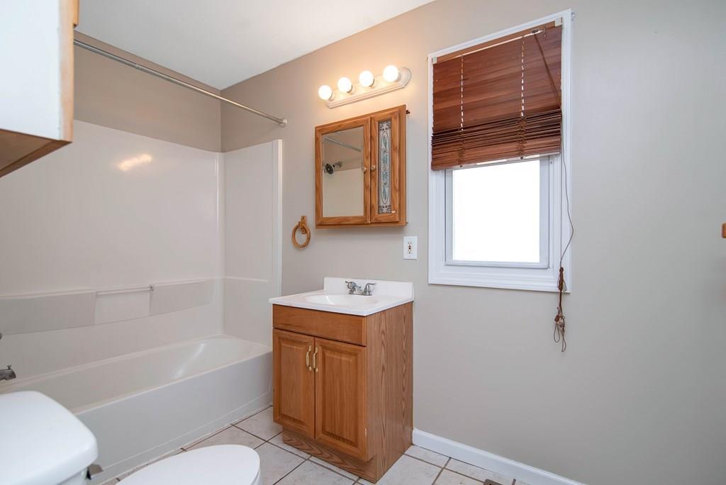 33 Goodwin Street Springfield, MA 01151 - Photo 16 of 27 a bathroom with a sink a toilet and bathtub