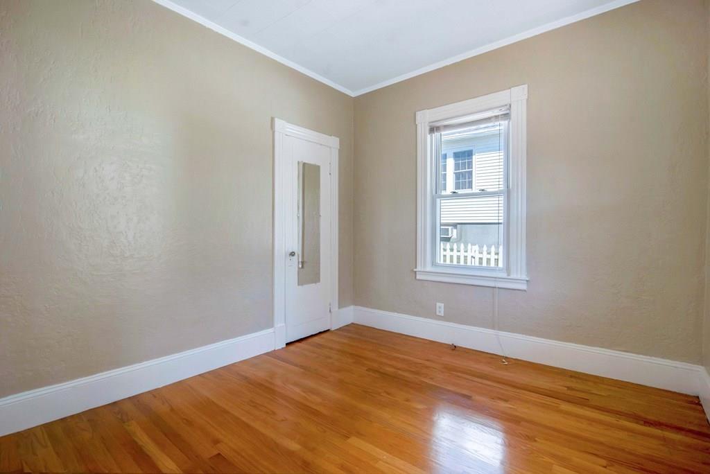 33 Goodwin Street Springfield, MA 01151 - Photo 5 of 27 a view of an empty room with wooden floor and a window
