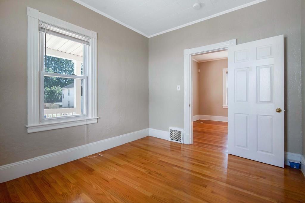 33 Goodwin Street Springfield, MA 01151 - Photo 6 of 27 an empty room with wooden floor and windows
