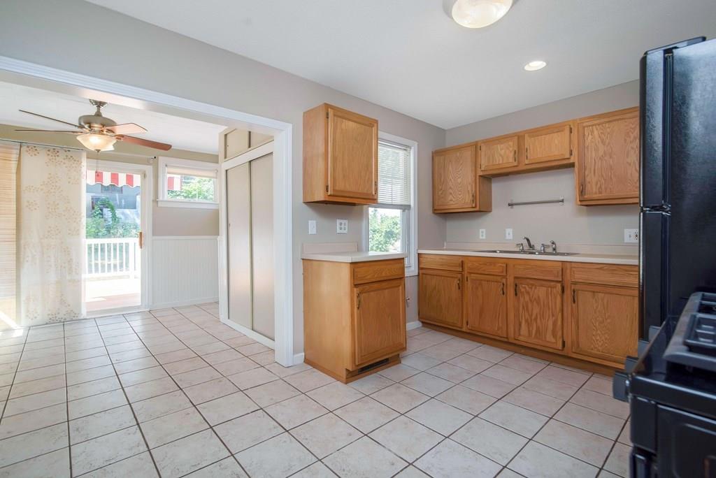 33 Goodwin Street Springfield, MA 01151 - Photo 7 of 27 a kitchen with a sink a stove cabinets and a window