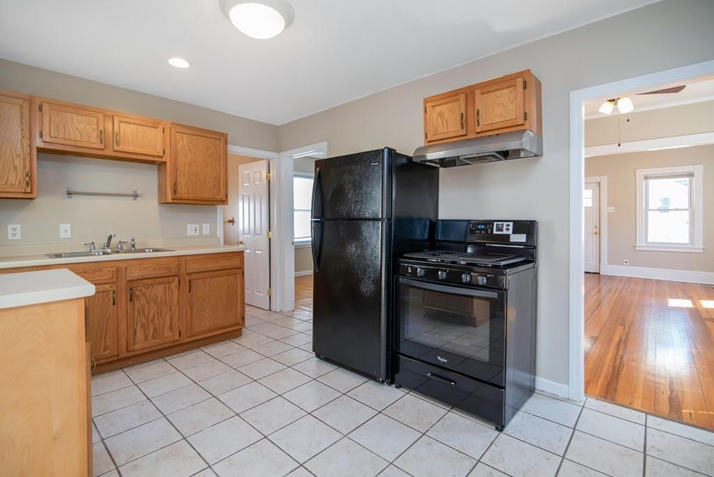 33 Goodwin Street Springfield, MA 01151 - Photo 10 of 27 a kitchen with stainless steel appliances a stove a sink and a refrigerator