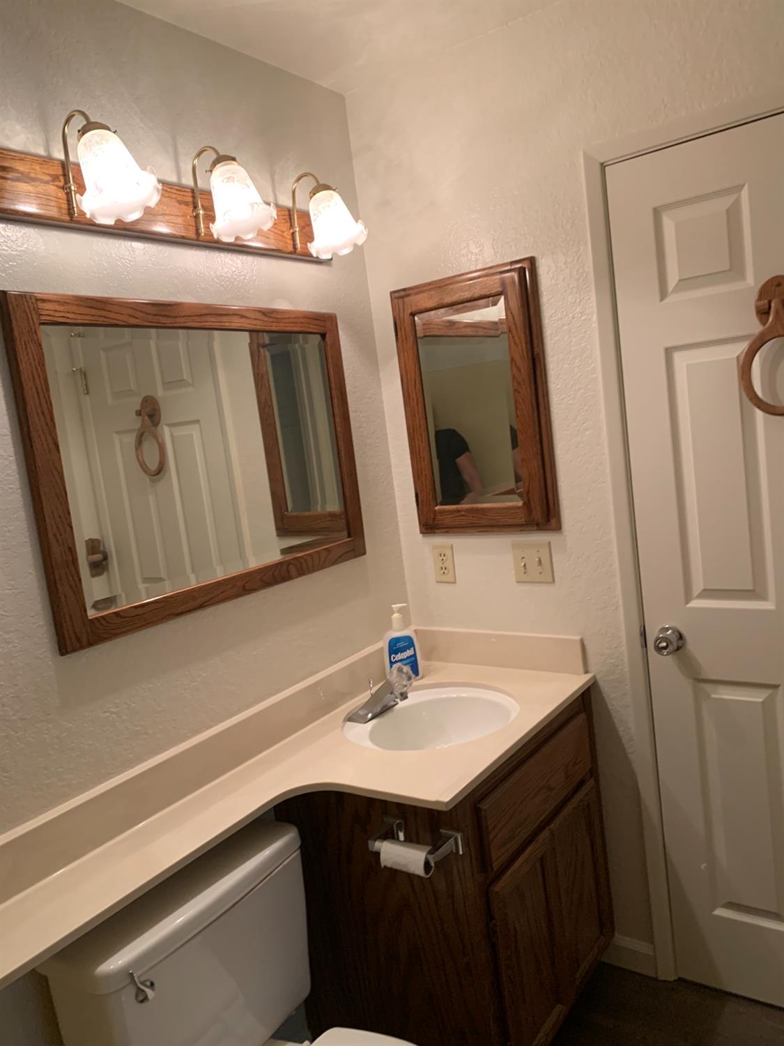 2429 Woodvale Drive Modesto, CA 95355 - Photo 4 of 9 a bathroom with a sink and a mirror