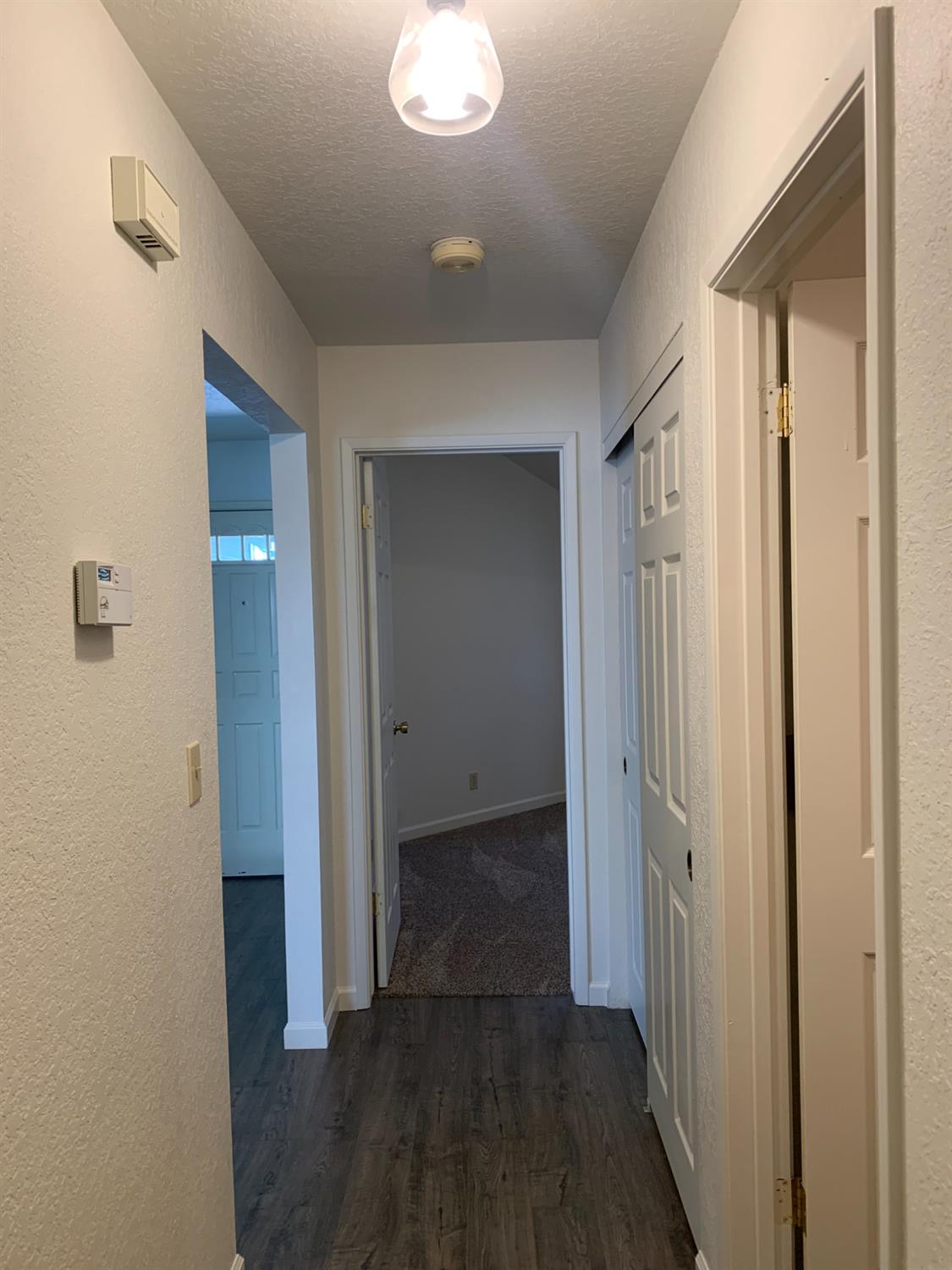 2429 Woodvale Drive Modesto, CA 95355 - Photo 6 of 9 a view of a hallway with wooden floor