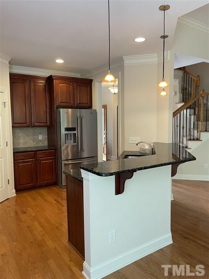 7370 Fontana Ridge Lane Raleigh, NC 27613 - Photo 11 of 27 a kitchen with stainless steel appliances granite countertop a refrigerator a sink and a stove