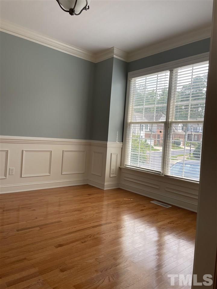 7370 Fontana Ridge Lane Raleigh, NC 27613 - Photo 15 of 27 a view of an empty room with wooden floor and a window