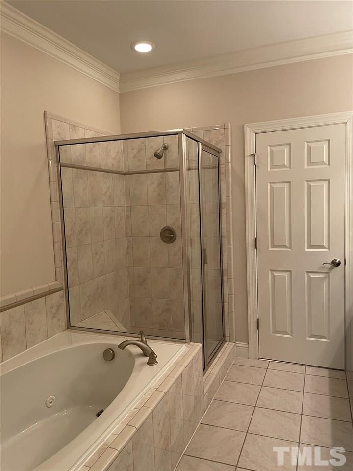 7370 Fontana Ridge Lane Raleigh, NC 27613 - Photo 26 of 27 a bathroom with a bathtub and a shower