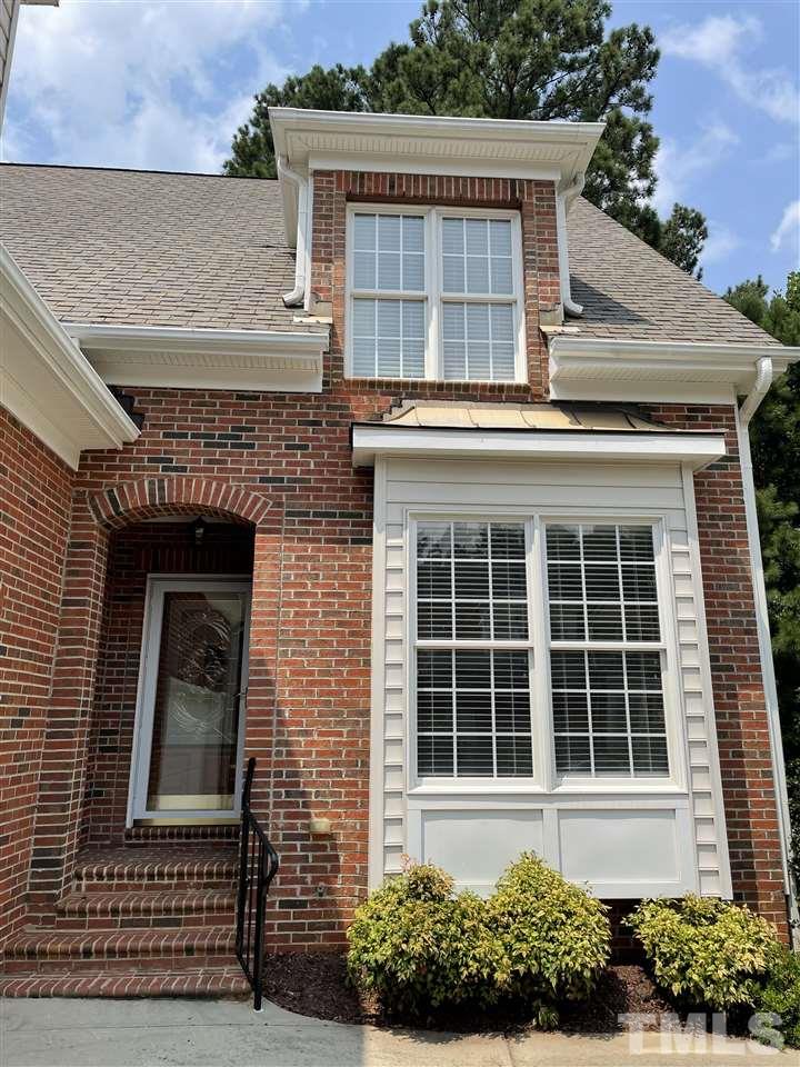 7370 Fontana Ridge Lane Raleigh, NC 27613 - Photo 6 of 27 front view of a brick house with a small yard