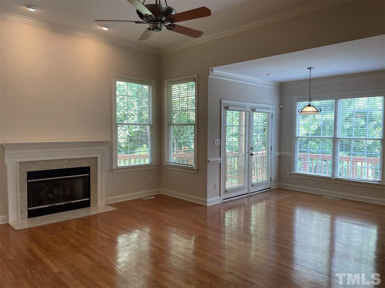 7370 Fontana Ridge Lane Raleigh, NC 27613 - Photo 7 of 27 a view of an empty room with wooden floor and a window