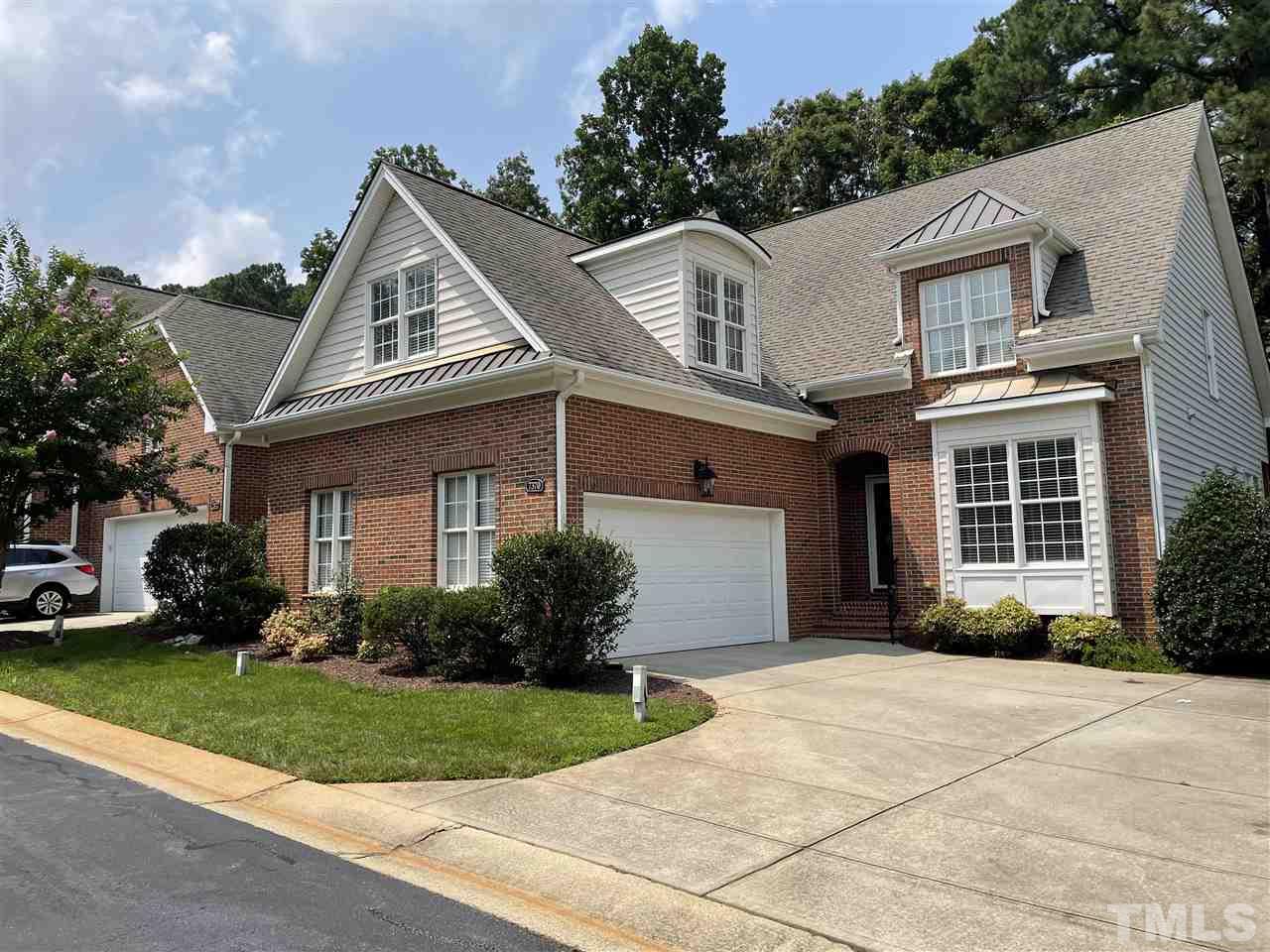 7370 Fontana Ridge Lane Raleigh, NC 27613 - Photo 9 of 27 a front view of a house with a garden