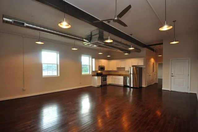 a view of a room with wooden floor