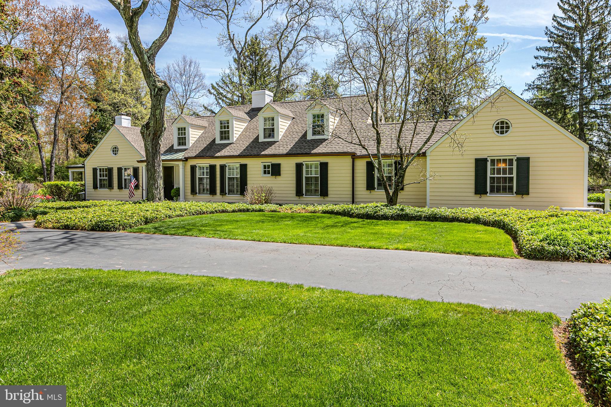 4445 Province Line Road Princeton, NJ 08540 - Photo 2 of 45 a front view of a house with a garden and trees