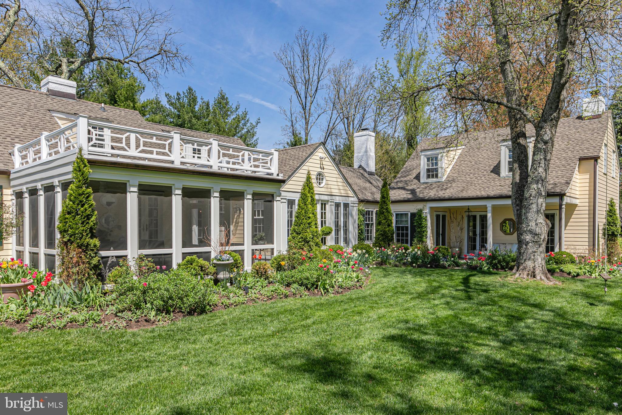 4445 Province Line Road Princeton, NJ 08540 - Photo 31 of 45 a view of a white house next to a yard with plants and trees
