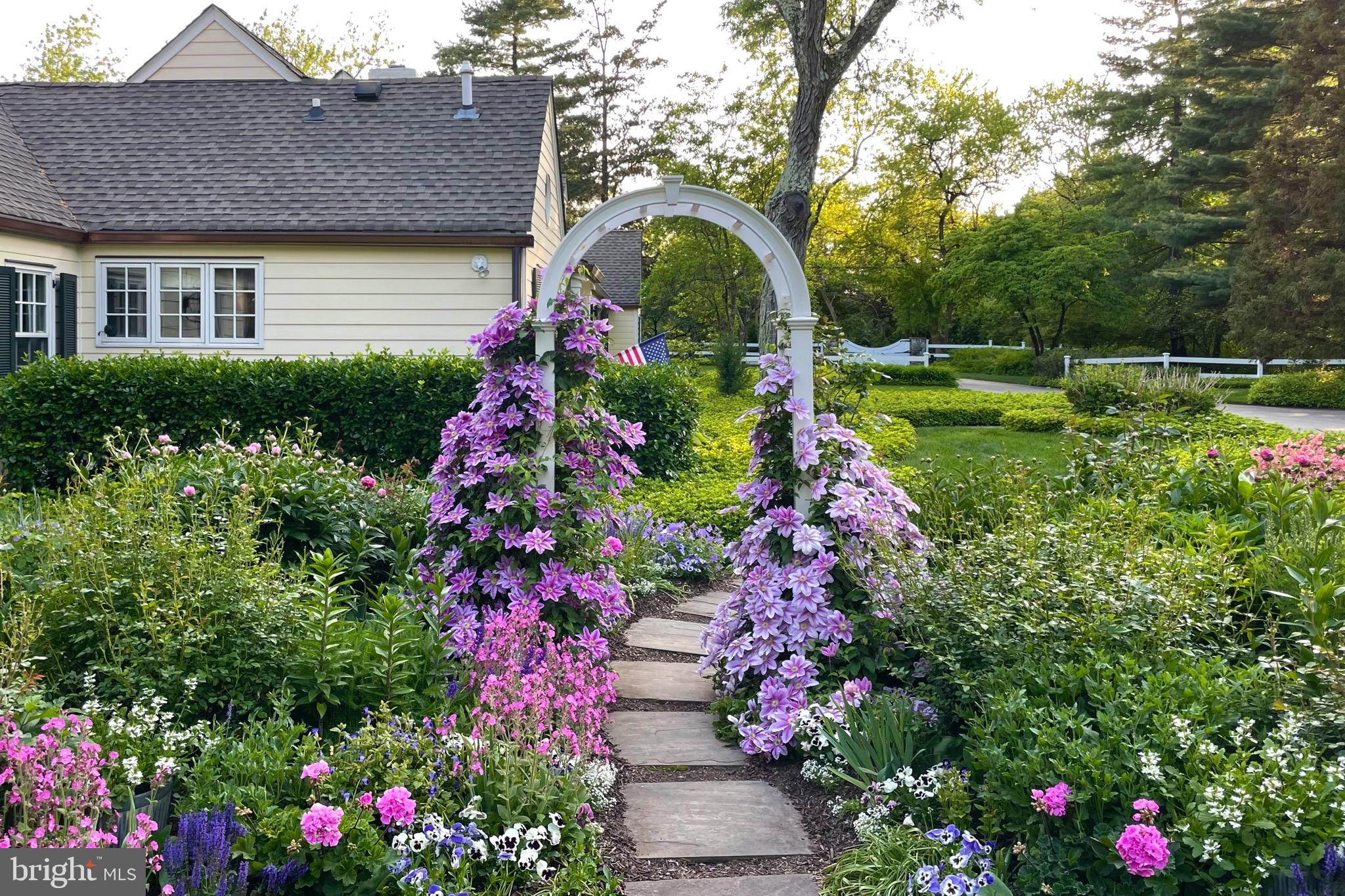 4445 Province Line Road Princeton, NJ 08540 - Photo 41 of 45 a view of a house with a big yard and flower plants