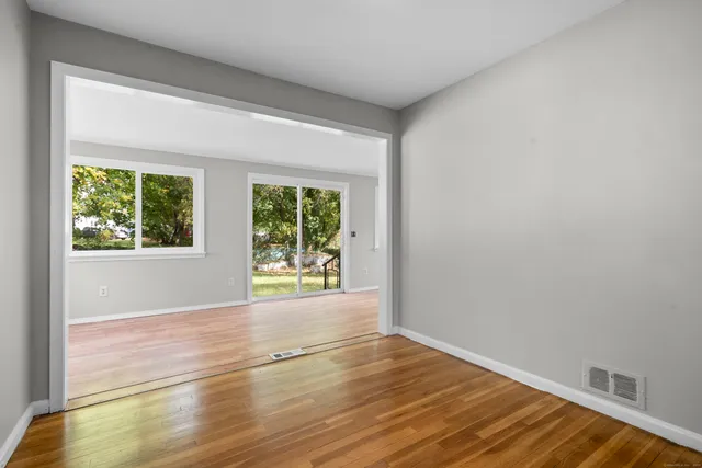 a view of a kitchen with wooden floor and a kitchen