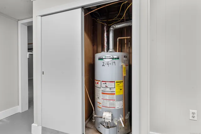 a view of an empty room with a fireplace and a window