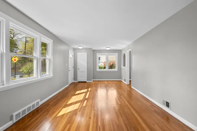 a kitchen with cabinets appliances and a wooden floor