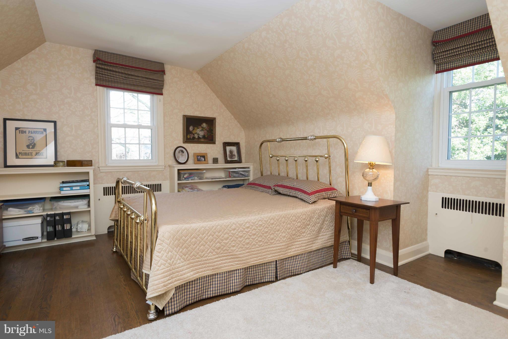 208 Taplow Road Baltimore, MD 21212 - Photo 14 of 30 a bedroom with a bed next to a window with chair