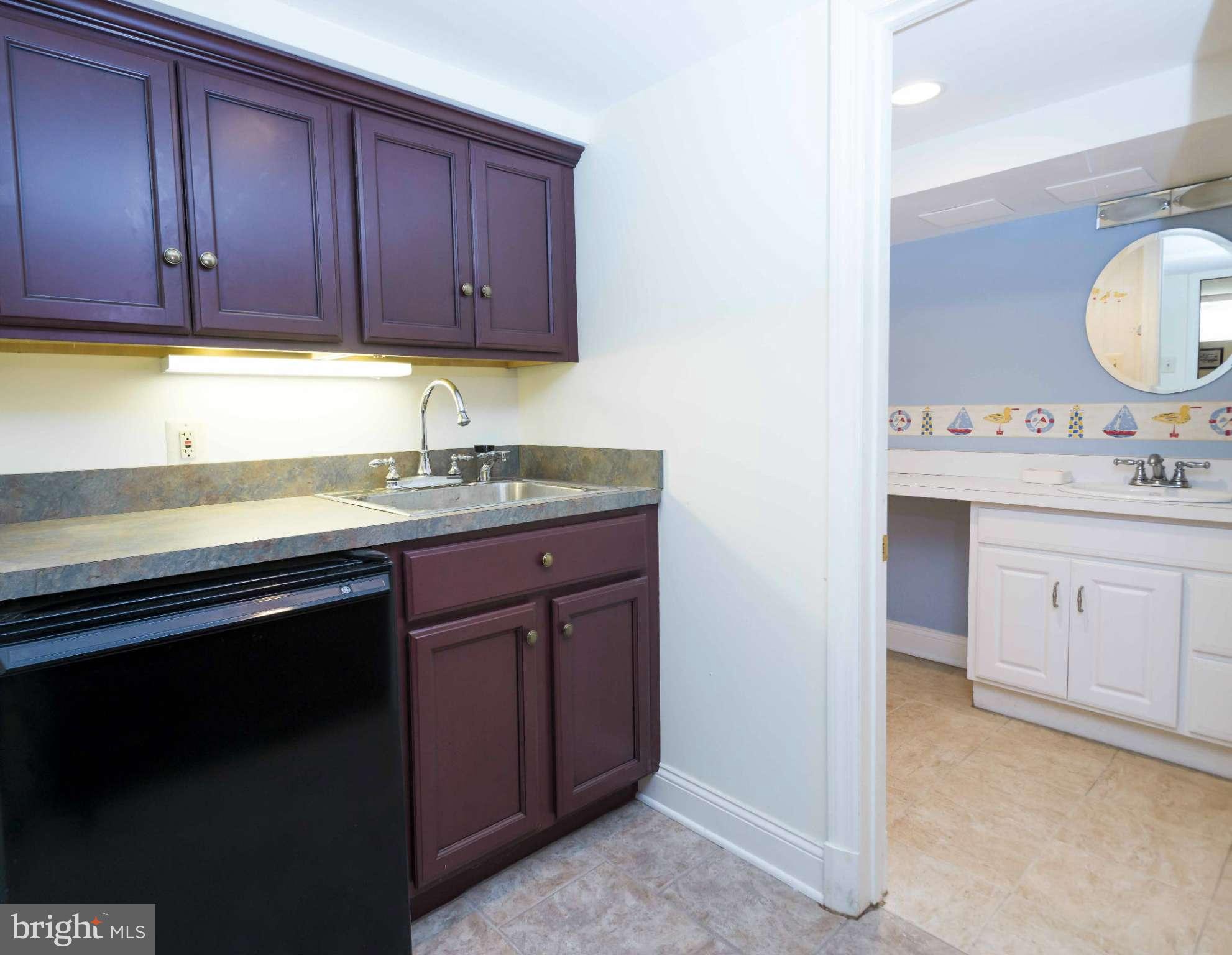 208 Taplow Road Baltimore, MD 21212 - Photo 24 of 30 a kitchen with a sink cabinets and stove