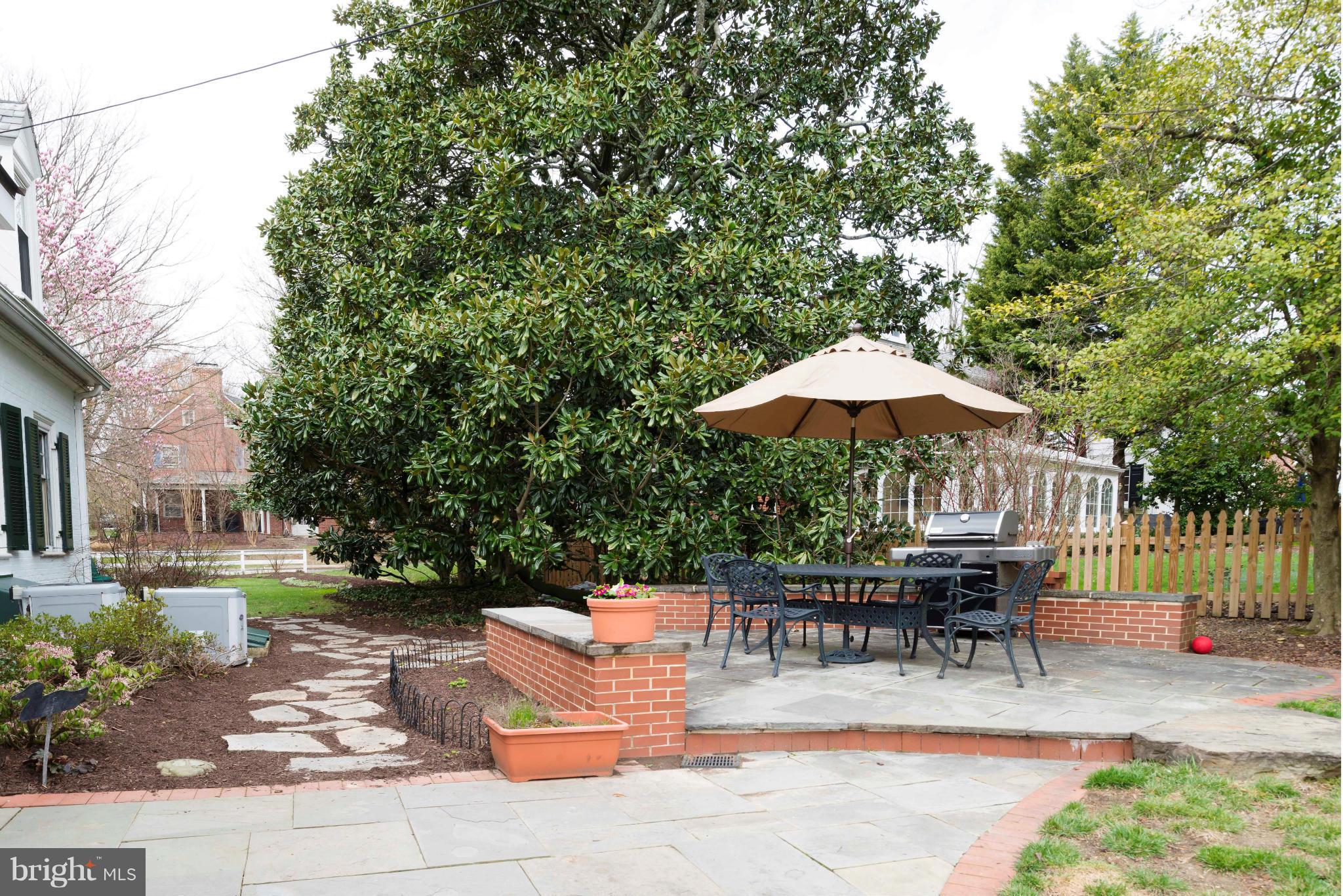 208 Taplow Road Baltimore, MD 21212 - Photo 27 of 30 a patio with a table and chairs under an umbrella