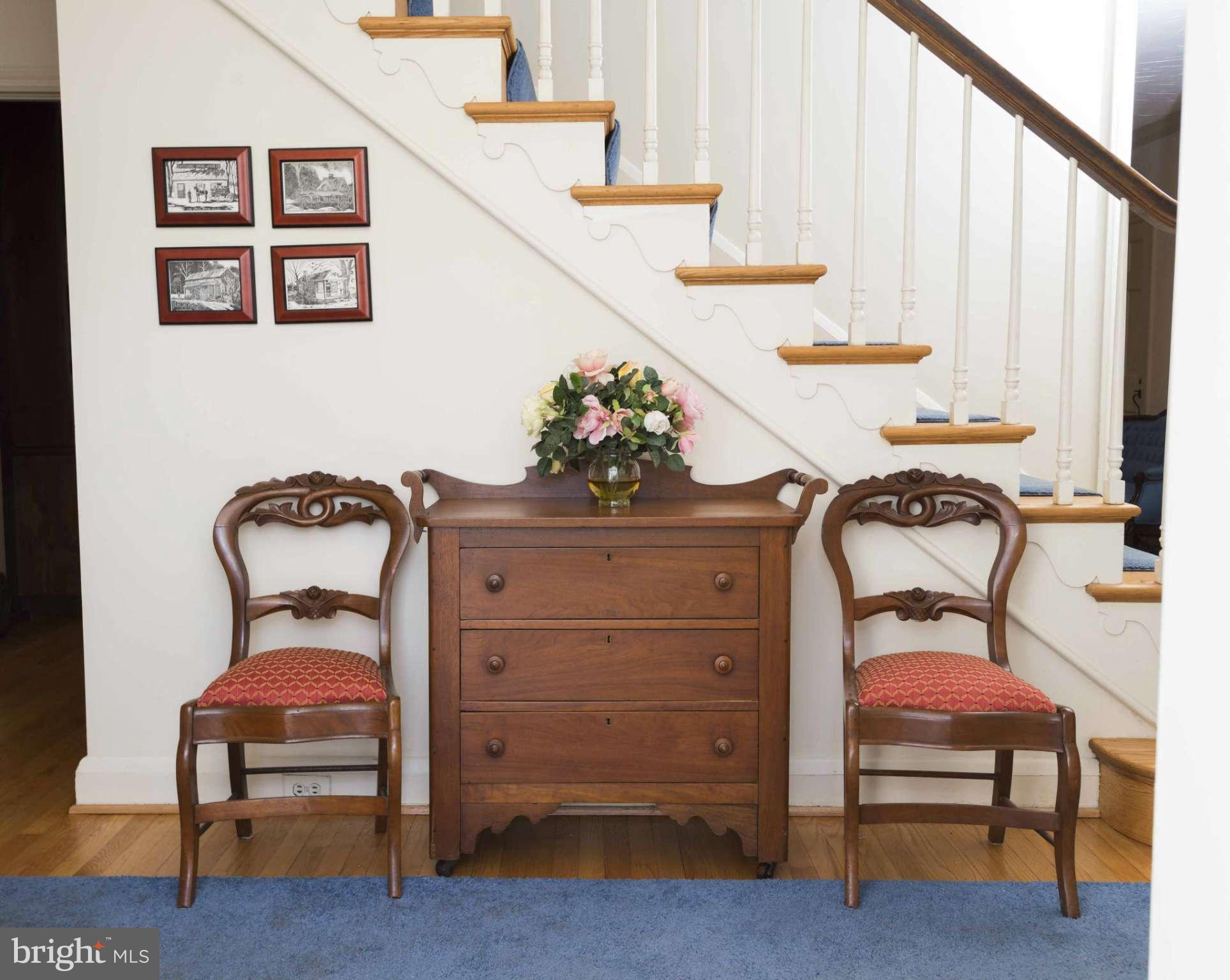 208 Taplow Road Baltimore, MD 21212 - Photo 4 of 30 a bedroom with furniture and paintings on the wall
