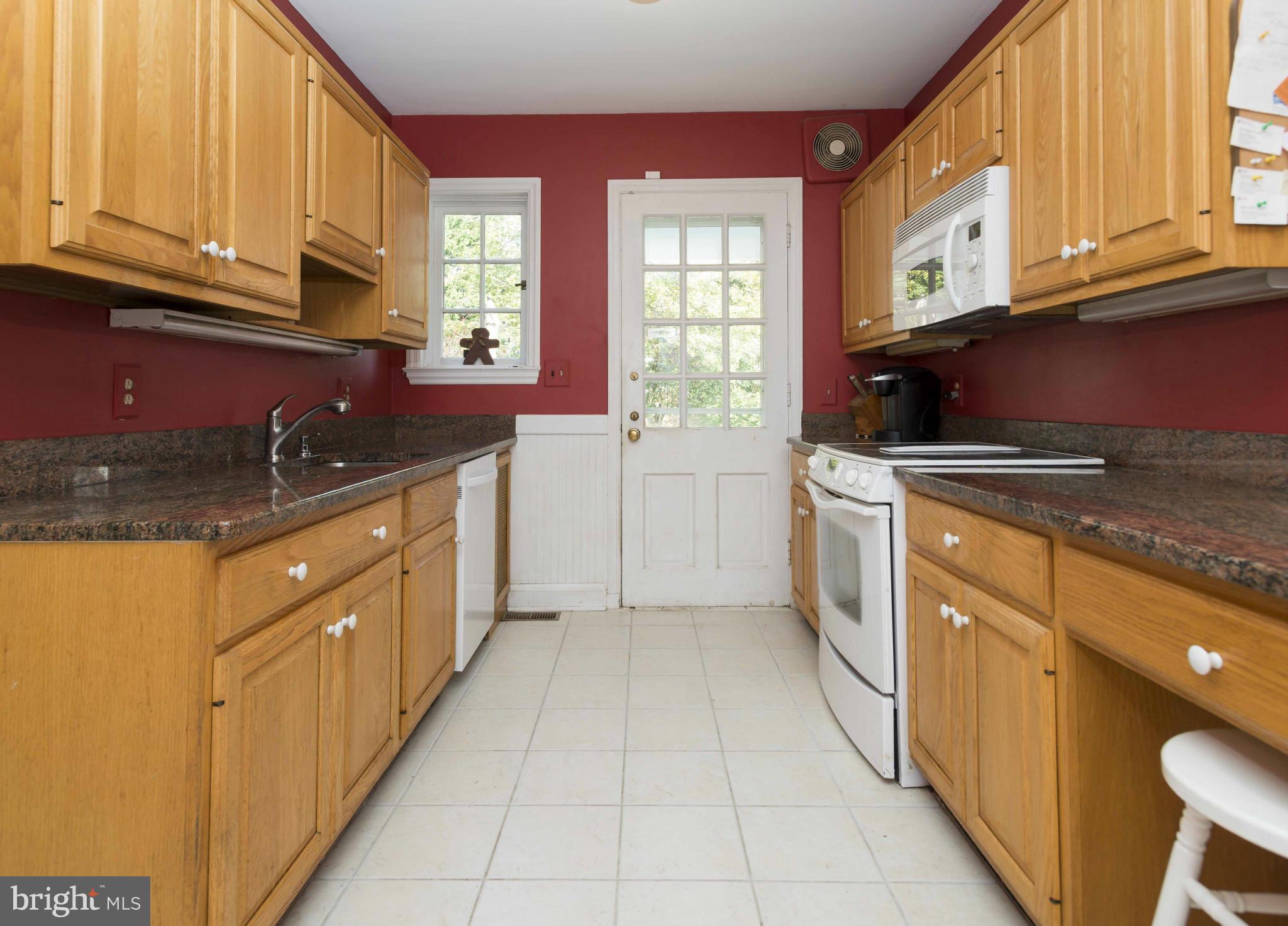 208 Taplow Road Baltimore, MD 21212 - Photo 9 of 30 a kitchen with stainless steel appliances granite countertop a stove sink and cabinets