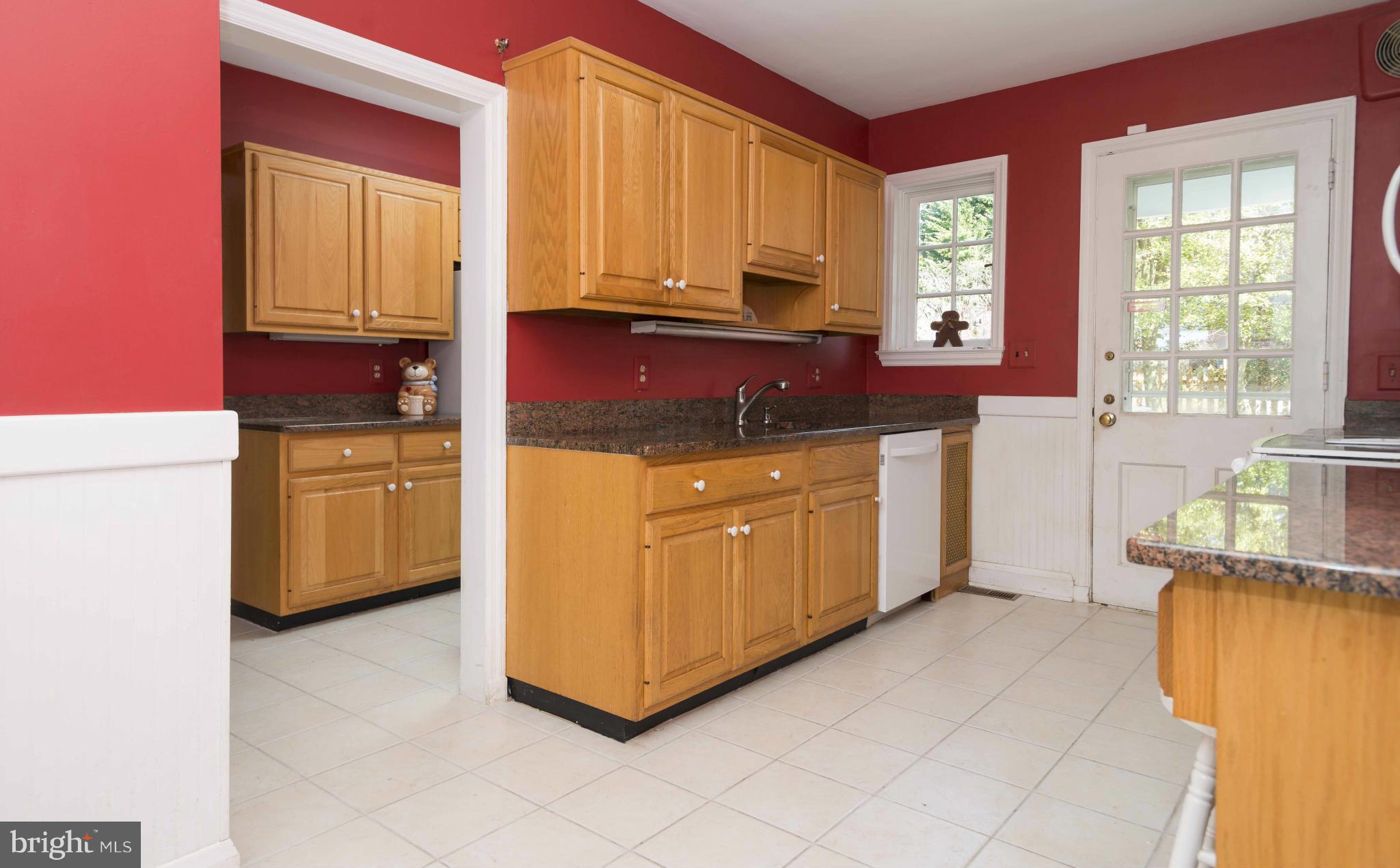 208 Taplow Road Baltimore, MD 21212 - Photo 10 of 30 a kitchen with stainless steel appliances granite countertop a stove a sink and a microwave