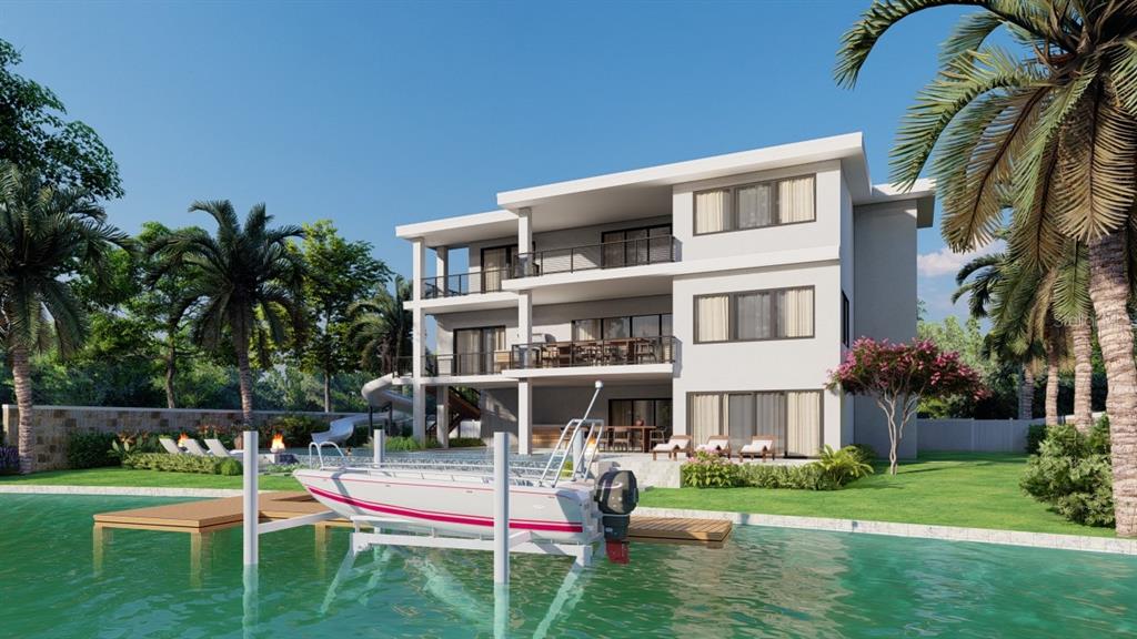 5179 Hidden Harbor Road Sarasota, FL 34242 - Photo 3 of 9 a front view of a house with a yard table and chairs