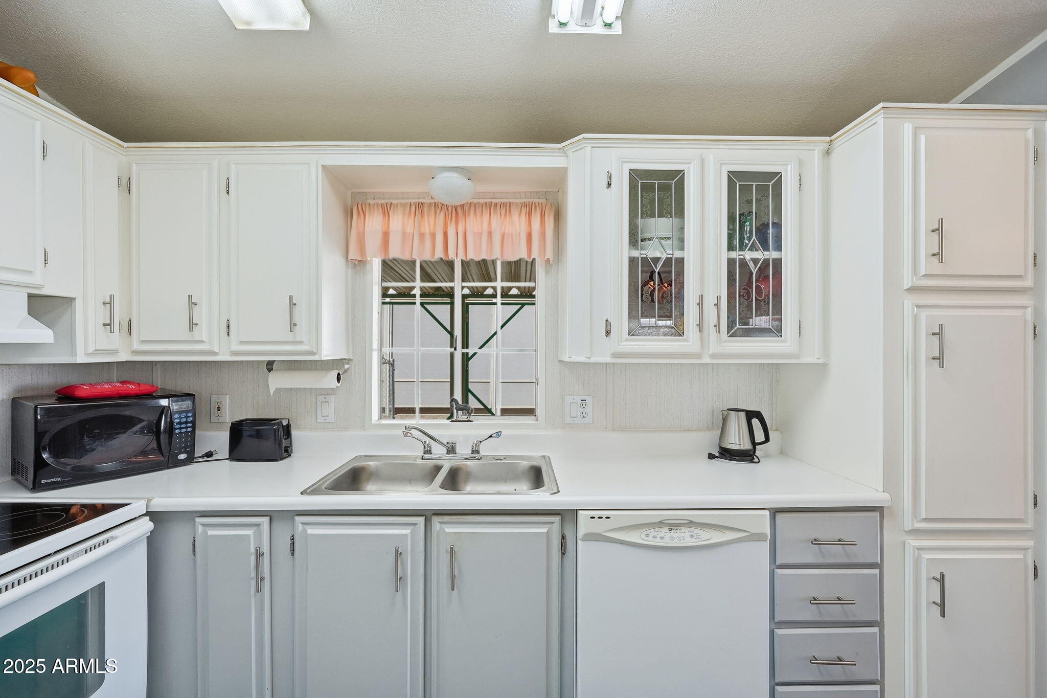 623 West Verde Lane Coolidge, AZ 85128 - Photo 10 of 34 a kitchen with stainless steel appliances white cabinets and a sink