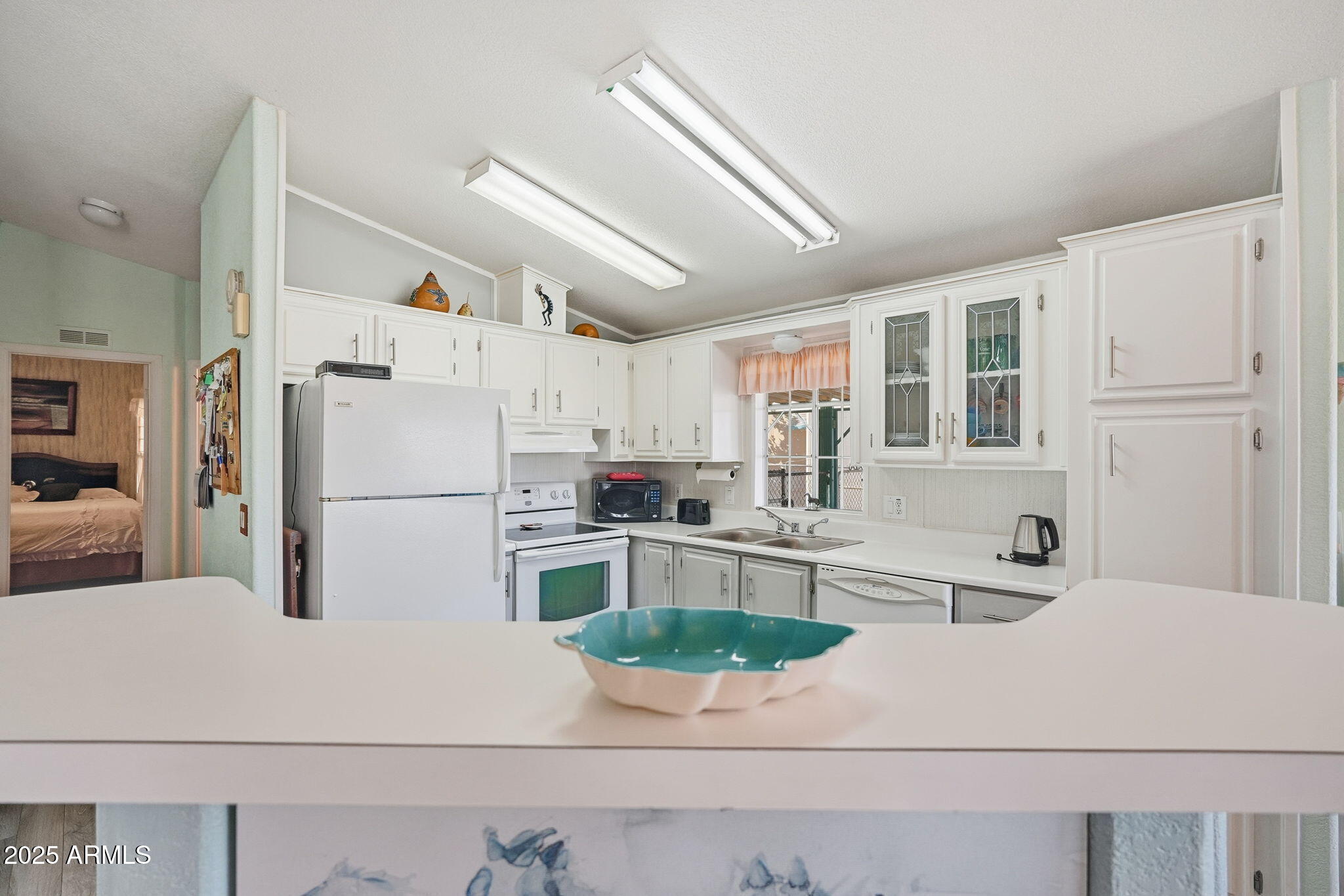 623 West Verde Lane Coolidge, AZ 85128 - Photo 12 of 34 a kitchen with refrigerator cabinets and white appliances