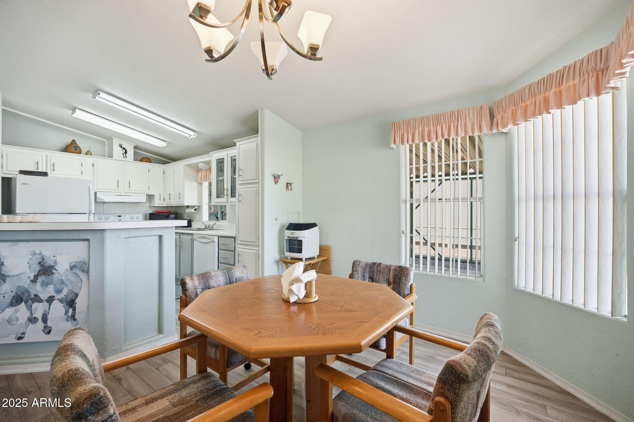 623 West Verde Lane Coolidge, AZ 85128 - Photo 15 of 34 a view of a dining room with furniture and a chandelier